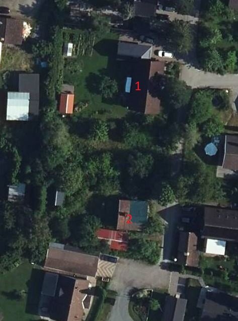Flygbild över två fastigheter med markerade gränser mellan byggnaderna.