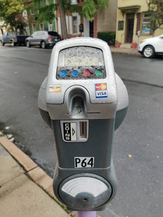 Moderniserad parkeringsmätare i USA som accepterar kortbetalning, fuktig av regn.