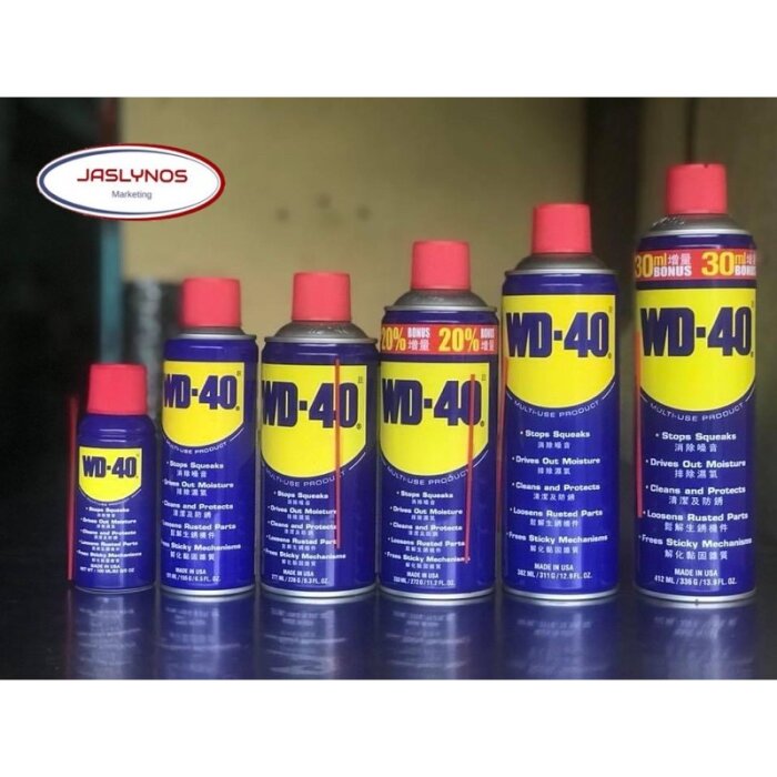 Flera flaskor med WD-40 i olika storlekar mot en otydlig bakgrund.