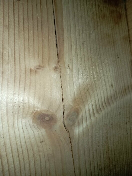 Trätakbjälke med små sprickor i ett vindsvåningsutrymme från ett hus byggt 1974.
