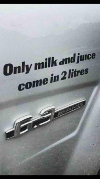 Text på bil "Only milk and juice come in 2 litres" ovanför modellbeteckning "6.3 AMG".