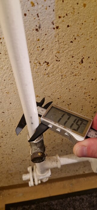 Mätskiva som visar 17 mm när den mäts över gängade rörledningar för att identifiera storlek.