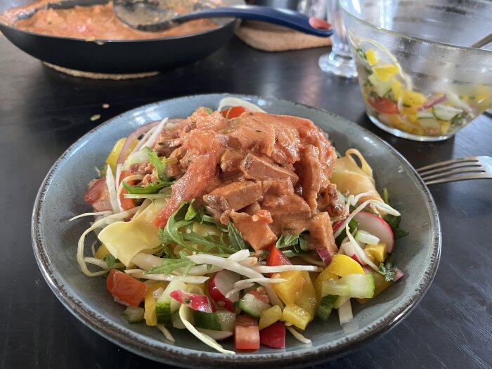 Pappardellepasta med rester av grillat sidfläsk i sås, sallad med grönsaker och basilika.