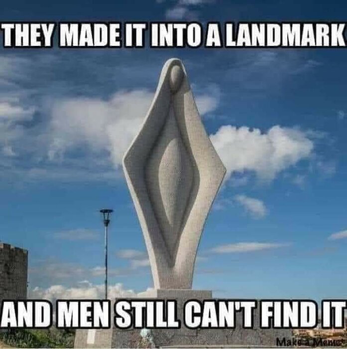 Stenskulptur utomhus med texten "They made it into a landmark and men still can't find it".