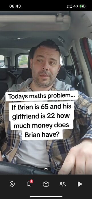 En man sitter inuti en bil och håller i ratten. En text på bilden lyder: "Todays maths problem... If Brian is 65 and his girlfriend is 22 how much money does Brian have?