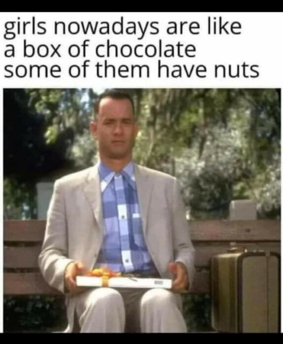 En man i kostym sitter på en bänk med en ask choklad i sitt knä. Texten ovanför lyder: "girls nowadays are like a box of chocolate some of them have nuts".
