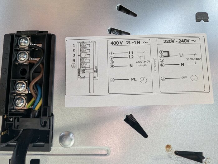 Kopplingsschema för spis med anslutna kablar, där L1 är svart och L2 är brun, tillsammans med instruktioner för 400V och 220V-240V installationer.