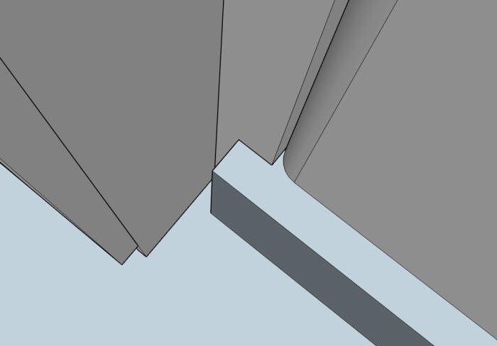 Närbild av garderob placerad mellan en vägg och en pelare med rundad kant, med en tydlig gap mellan garderobens högra sida och pelaren.