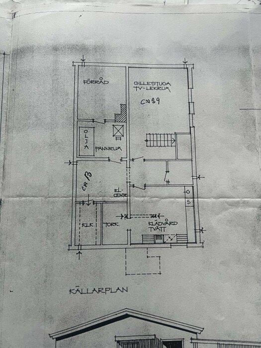 Original ritning som visar källarplan med rum för förvaring, olja/pannrum, gillestuga, elcentral, klädvård/tvätt och torkrum.