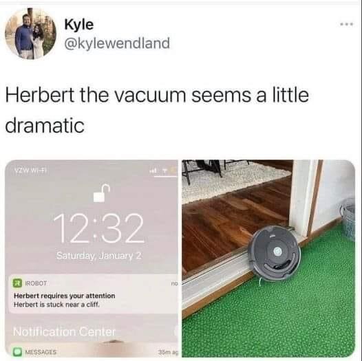 Tweet humorously points out a notification from a robot vacuum claiming to be stuck near a cliff. The vacuum is shown on a slight step down between rooms.