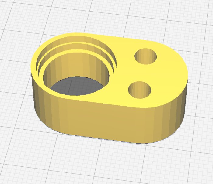 3D-utskriven gul distans med ett stort runt hål och två mindre runda hål bredvid, designad för ett byggprojekt.