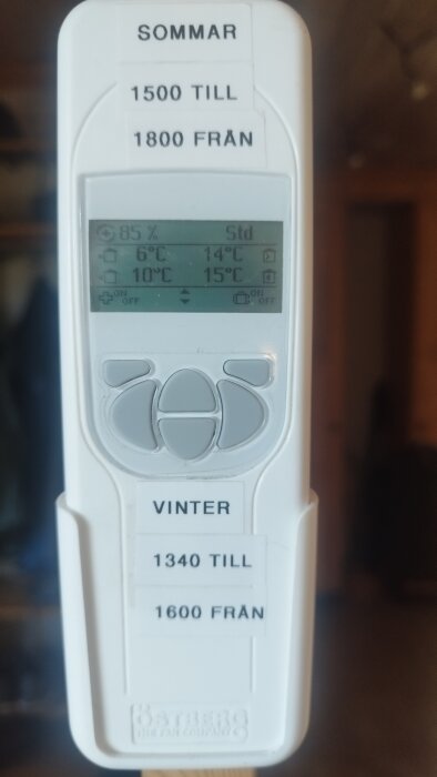 En termostat med temperaturinställningar för sommar och vinter visas, med display som visar nuvarande inomhustemperatur och luftfuktighet.