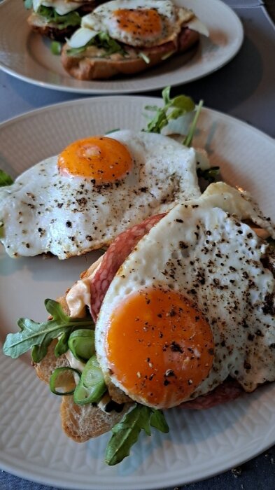 Två smörgåsar med ostgifflar, Srirachamajonnäs, ruccola, salladslök, salami Milano, ost och stekta ägg.