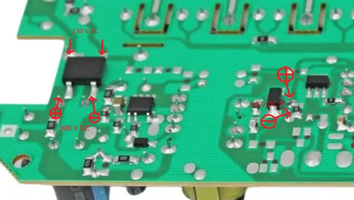 Kretskort med markeringar för mätning av spänningar: 230 V AC, 300 V DC, och 12 V DC. Anpassat för felsökning med multimeter.