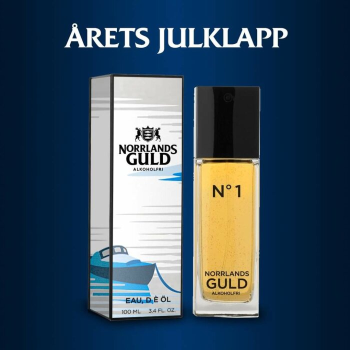 Flaska med Eau de ÖL "Norrlands Guld" No 1, alkoholfri doft, i förpackning med marin motiv på blå bakgrund, med texten "Årets Julklapp".