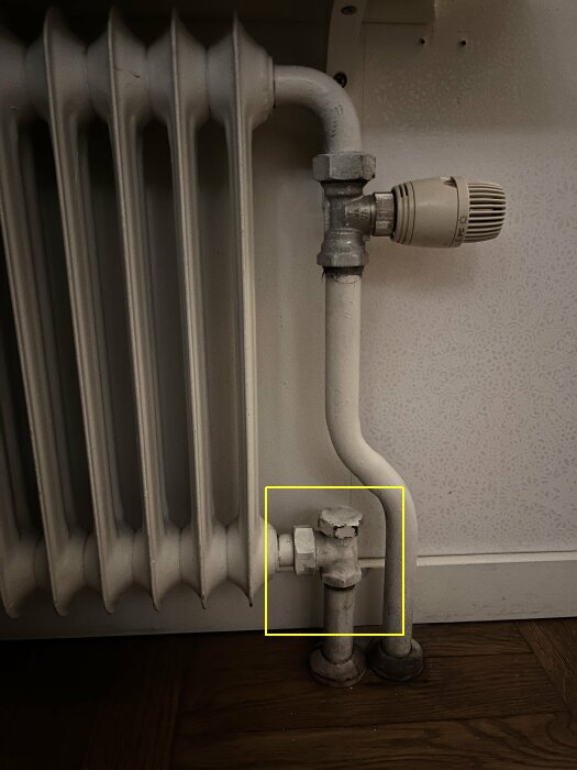 Ventil under radiator med vridventil och röranslutningar.