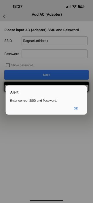 Alertmeddelande på en mobilskärm visar "Enter correct SSID and Password" när användaren försöker ansluta en AC-adapter.