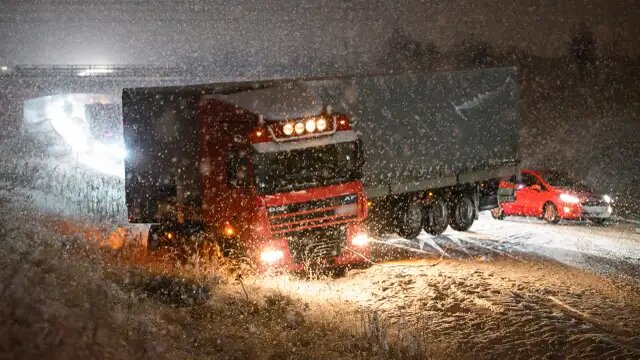 Lastbil i snöblockad på E22, max 1 cm snö och trafikstockning.