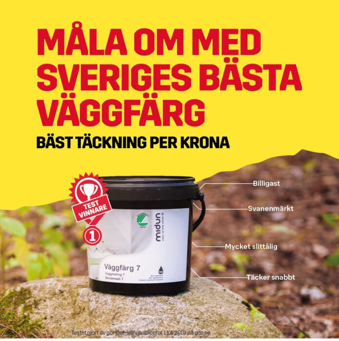 Burk med Midun väggfärg på sten, gul bakgrund. Text: "Måla om med Sveriges bästa väggfärg. Bäst täckning per krona." Testvinnare-etikett på burken.