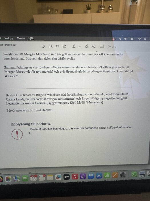 Besked från nämnd visas på datorskärm. Text om beslut och belopp om 329 786 kr. Juridiska namn listade, beslut kan ej överklagas.