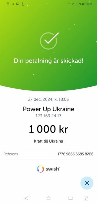 Skärmbild av en Swish-betalning på 1000 kr till "Power Up Ukraine" med datumet 27 dec 2024 och meddelandet "Kraft till Ukraina".