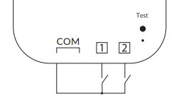 Schematisk ritning av en elektrisk kopplingsenhet med markerade anslutningar COM, 1, 2 och en testindikator.