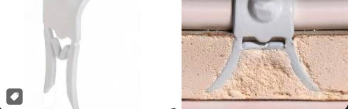 Kabelklammer som håller fast en kabel mot en väg av gips, med gipsdamm synligt runt klammern.