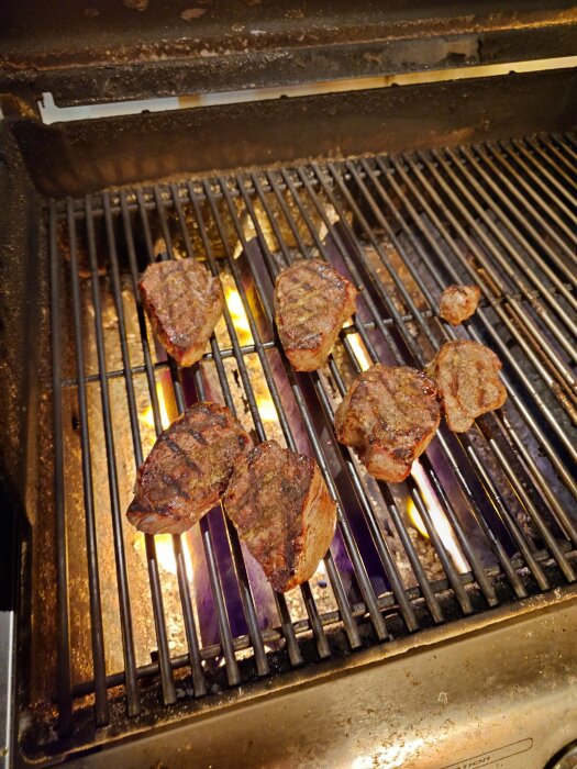 Grillad rostas på en het grill med lågor under gallret.