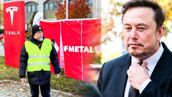Man i reflexväst står framför Tesla- och IF METALL-skyltar. En annan person justerar sin slips. Ljusspegling på bilden.