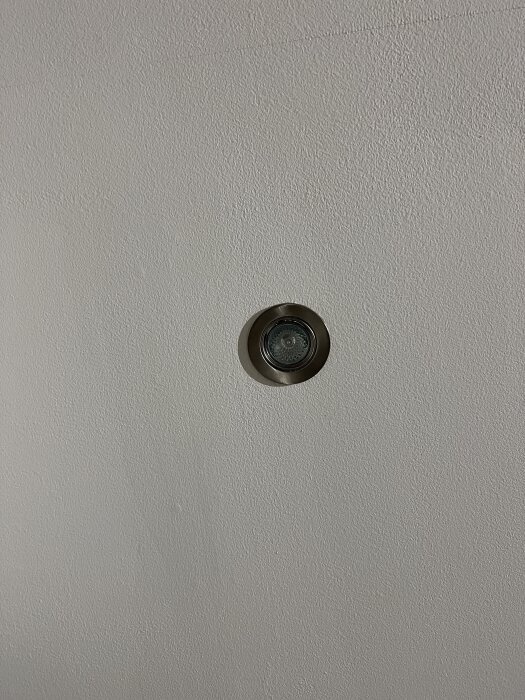 Metal-framed spotlight installed in a ceiling, similar to the Philips Hue design the user wants for their living room.