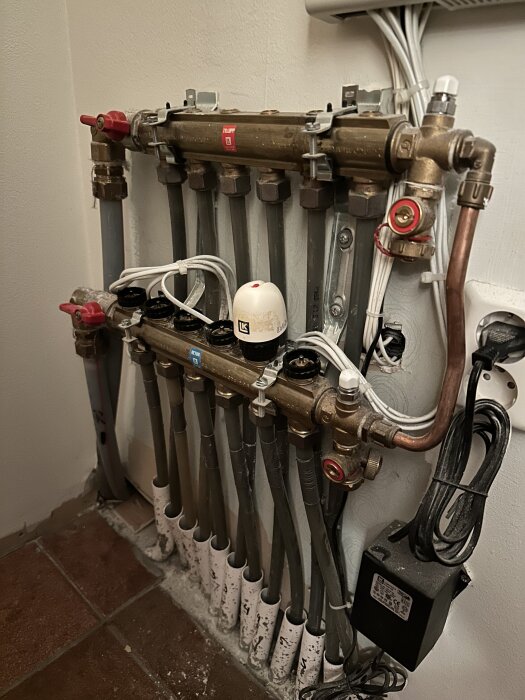 Golvvärmesystem från LK-system anno 2003 med flera anslutna slingor och ventiler; fokus på slinga nummer två som har problem med piggen.