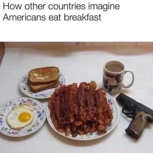 Bacon, ägg, toast, en kopp kaffe och en pistol på ett bord, med text om hur andra länder föreställer sig att amerikaner äter frukost.