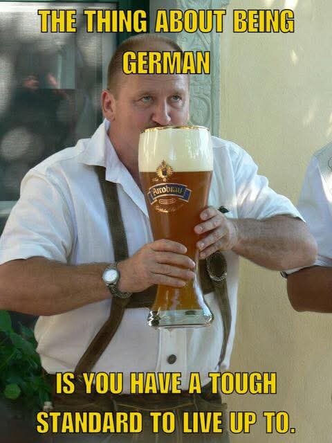 Man i lederhosen håller ett stort ölglas med text: "The thing about being German is you have a tough standard to live up to.