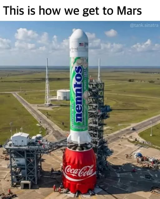 Raketen ser ut som en stor Mentos-rulle stående på en Coca-Cola-flaska på en uppskjutningsramp under en blå himmel.
