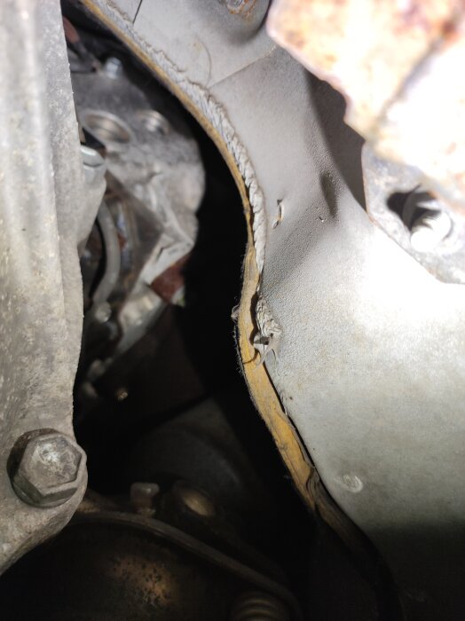 Bilden visar bakkanten av en 20 år gammal bilmotor, oskadad utan synligt oljeläckage, under installation av värmare i campingbuss.