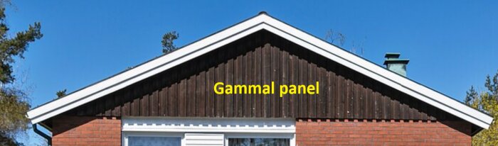 Gavelsidan på ett hus med gammal brun träpanel markerad, omgiven av rött tegel och blå himmel i bakgrunden.