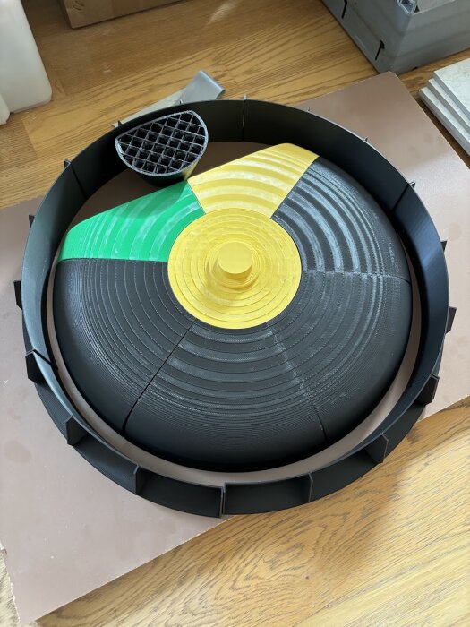 3D-printad form i färgglada segment för handfat, redo för gjutning med fiberarmerat flytspackel. Runda lager och trist omgivning syns.
