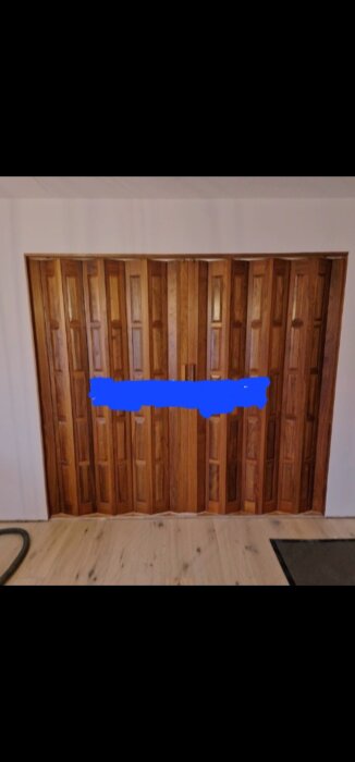 Träpanel i utrymme med gult golv och vit vägg, mönstrad design med blått område.