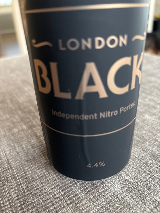 Burk med London Black Independent Nitro Porter, 4,4% alkoholinnehåll, på bord. Firande av projektets färdigställande.