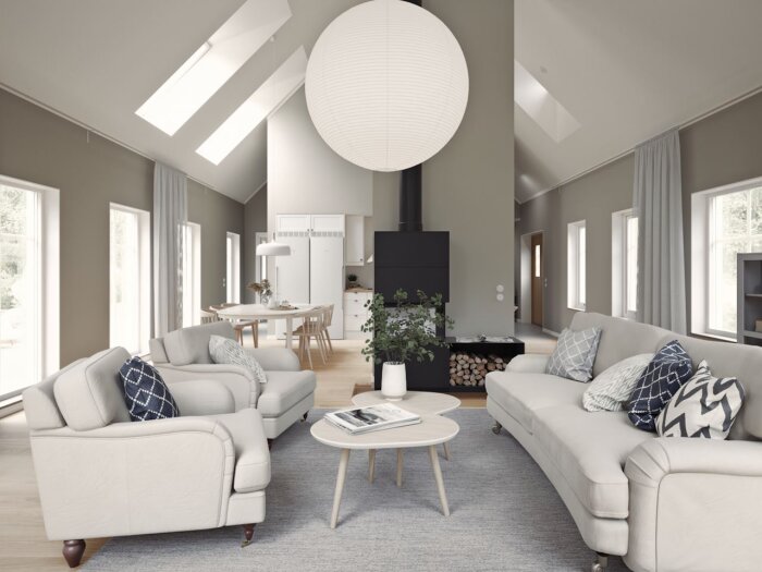 Modernt vardagsrum med högt i tak, stora fönster och stilrena möbler. En stor rund lampa hänger från nockbalken.