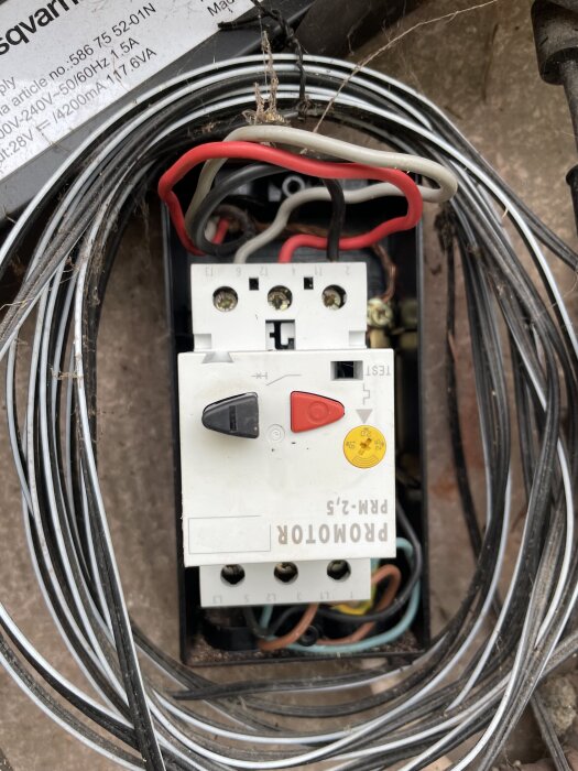 Elektrisk centralmatning med kablar och en strömbrytare monterad i en låda.