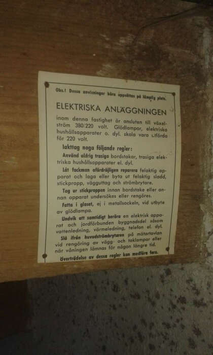 Gammal skylt med säkerhetsanvisningar för elektriska anläggningar, inklusive regler för användning och reparation av elektriska apparater.
