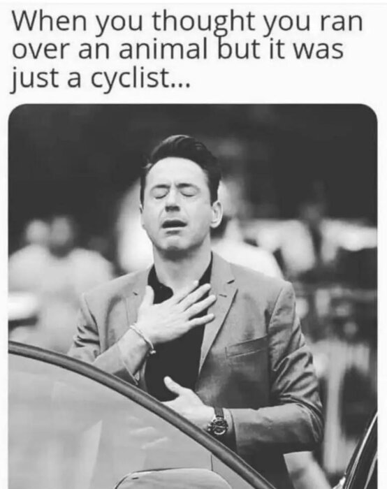 Person i kostym vid bilen, hand på bröstet. Text ovan: "When you thought you ran over an animal but it was just a cyclist.