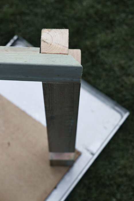 Närbild på trästolpar och regel avsedda för ett utekök eller omplanteringsbänk, med kapning och sammanfogningsteknik i fokus.