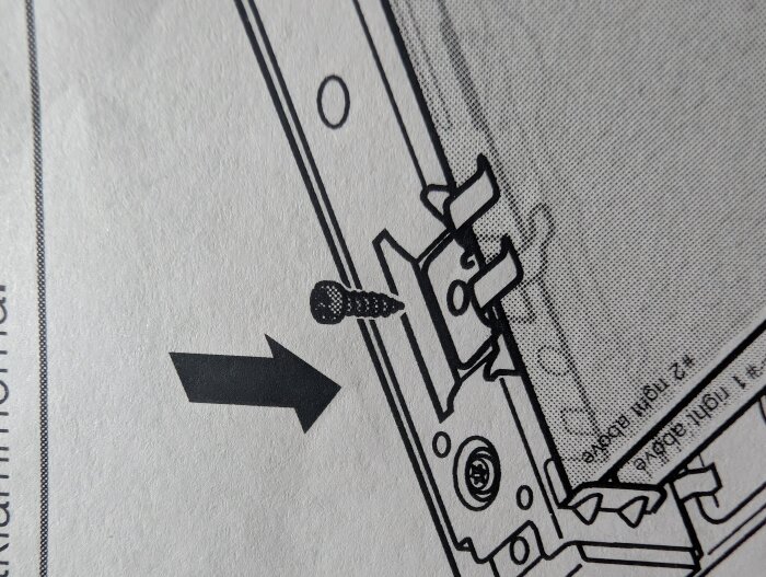 Illustration av en skruv och en pil som pekar mot monteringspunkten för att ta bort frontglas enligt en manual.