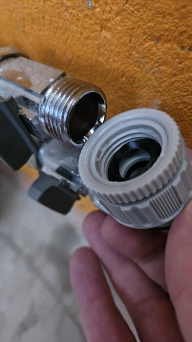 Ballofix-ventil i källare med trädgårdsslangskoppling där vredet tar emot kopplingen.