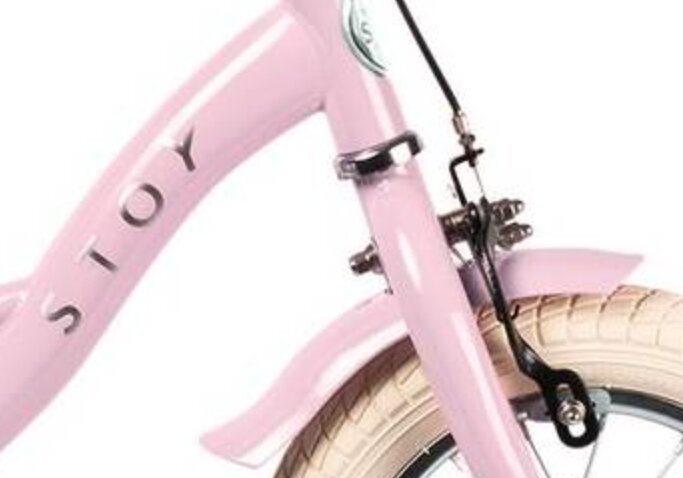 Främre del av en rosa cykel med ett böjt fäste.