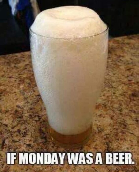 Ett glas med överflödigt ölskum och texten "If Monday was a beer" på en marmorliknande yta.