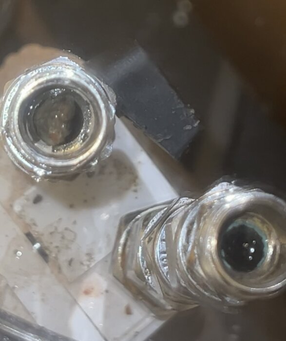 Metallrör med blockerade öppningar av stenar, inzoomad bild från ett köksprojekt visar potentiell orsak till lågt vattentryck.