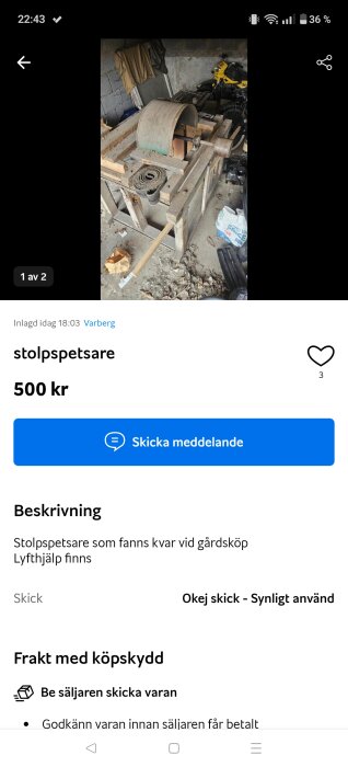 Stolpspetsare till salu, placerad på ett bord i ett garage. Verktyg och material syns runtomkring, och en gul motorcykel i bakgrunden.